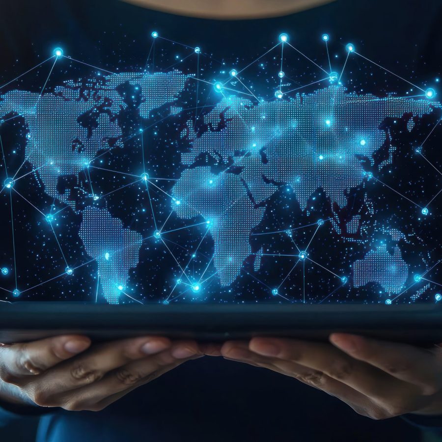 A person holding a tablet that displays a digital world map with location pins, symbolizing global connectivity and technology
